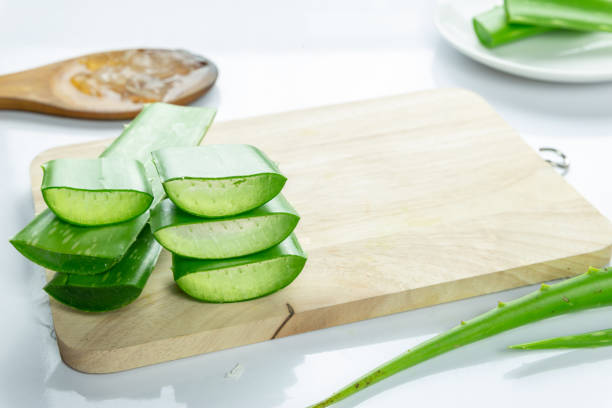 istock Aloe Vera sliced on wood spoon isolated on white background. 1281063431