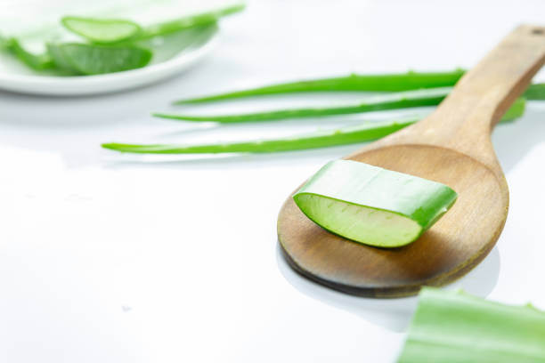 istock Aloe Vera sliced on wood spoon isolated on white background. 1281064019