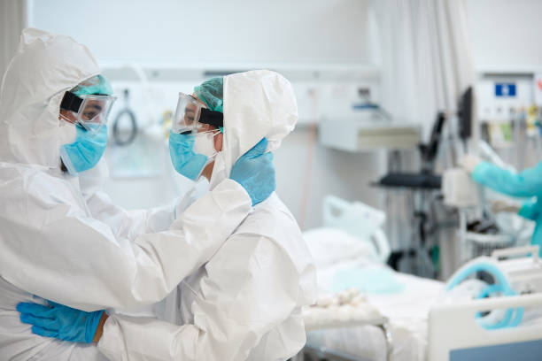 istock Medical Team in Protective Workwear Embracing in Support 1281064245
