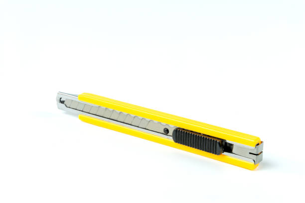 istock The yellow stationery knife isolated on white background. 1281068509