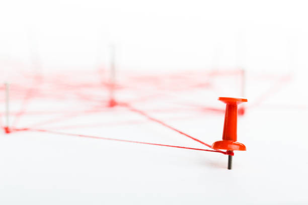 A large mesh of pins connected with a cord. Communication, network concept. Red