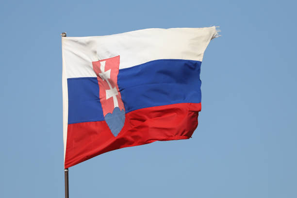 istock Slovakian flag flying on flagpole on blue sky background 1281070453