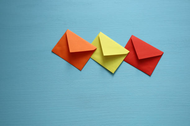 Close-up of color envelopes on blue background