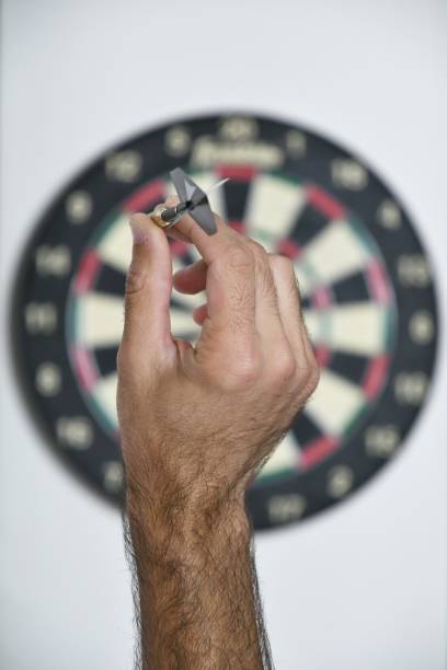 istock Close-Up Of Hand Holding Clock Against Blurred Background 1281070721