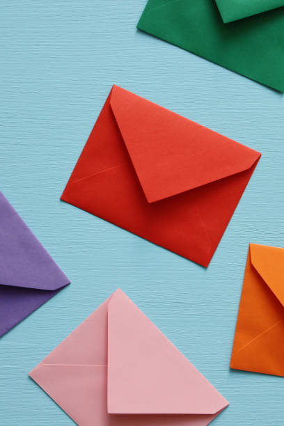 Close-up of color envelopes on blue background