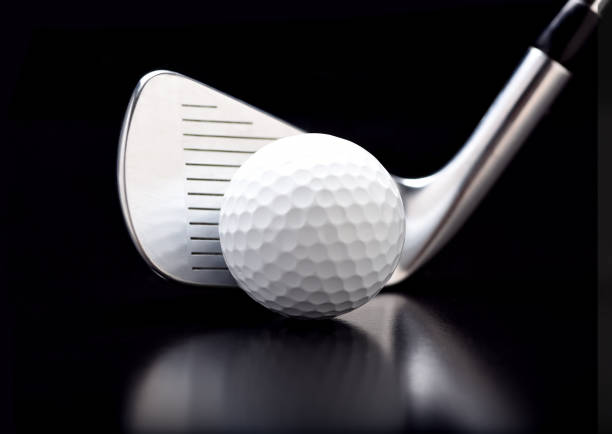 istock Closeup of a nine iron with a golf ball on black with reflection. 1281072544