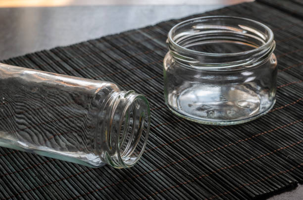 istock Random empty glass jars on a dark bamboo napkin. 1281073819