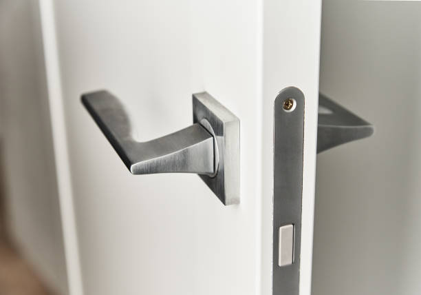 istock Silver door handle on a white door.  Furniture accesories, interior element 1281073975