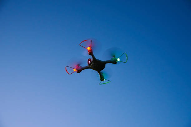 Drone quad copter toy against sunset sky