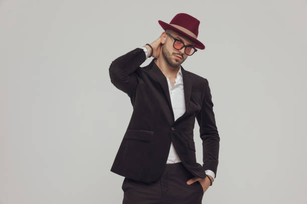 istock Thinking fashion model holding hand on neck, wearing hat 1281075056