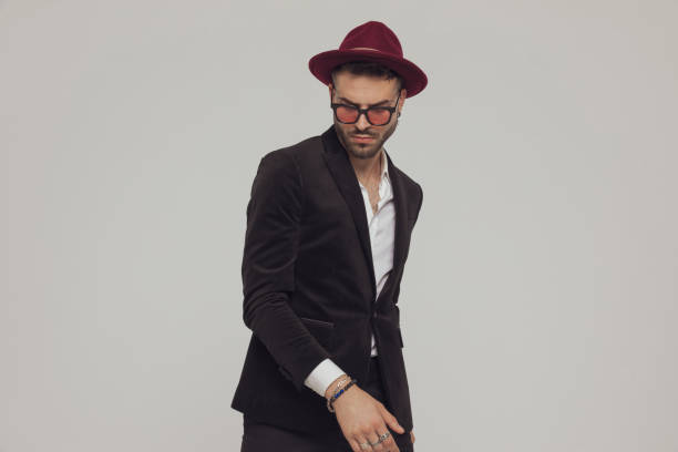 istock Thoughtful fashion model looking down, wearing hat and sunglasses 1281075106