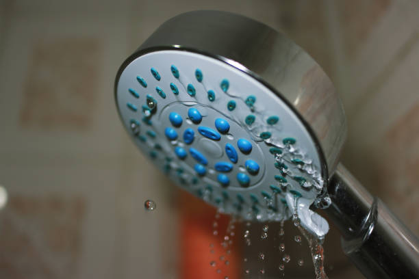 istock Shower Head And Falling Water Droplets Close-up 1281075113