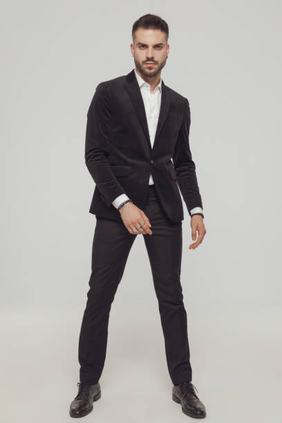 istock Tough fashion model wearing suit and standing 1281075182