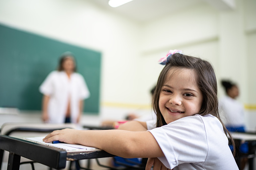 Portrait of a happy special needs student in the classroom