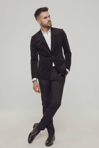 istock Confident fashion model looking away while standing with legs crossed 1281075368