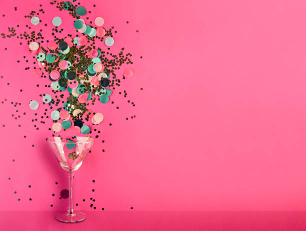istock Close-up of martini glass spilling confetti 1281075432
