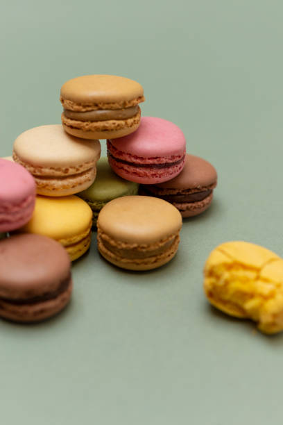 istock Colored tasty macaroons over a green background. 1281076228