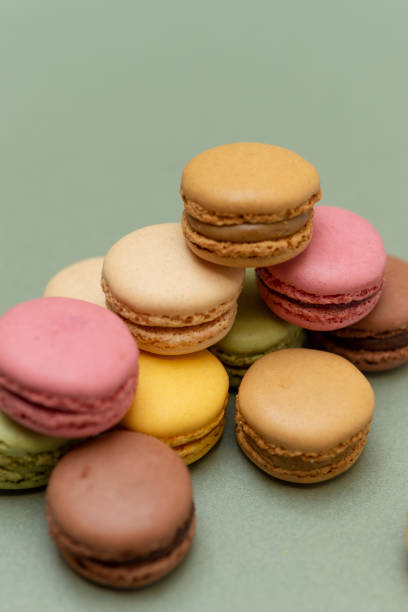 istock Colored tasty macaroons over a green background. 1281076232