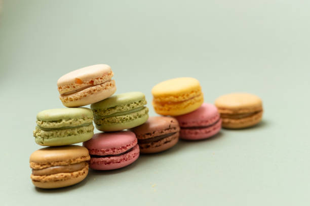 istock Colored tasty macaroons over a green background. 1281076234