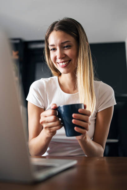 istock Charming young women looking at laptop and smiling 1281076308