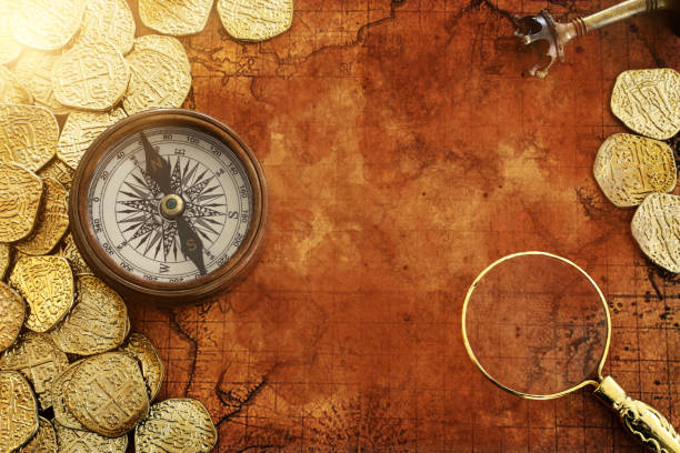 istock Old compass and gold coins treasure over antique map. top view 1281076328