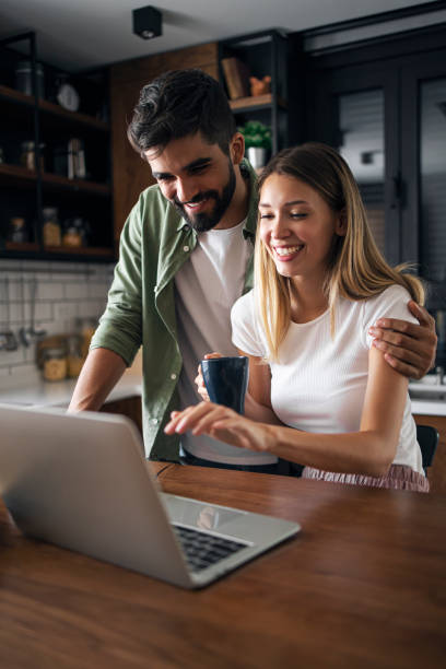 istock Cheerful couple having fun on laptop 1281076330