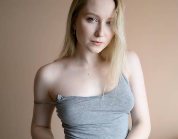 istock Woman posing against beige wall. 1281077980