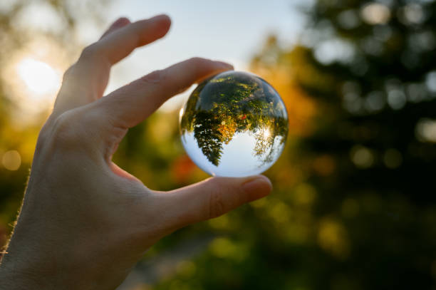 istock Hand held lensball in autumn forest. 1281078738