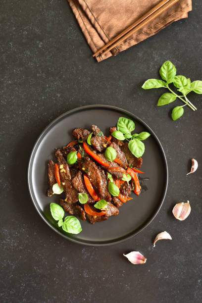istock Thai beef stir-fry with pepper and basil on plate 1281080981