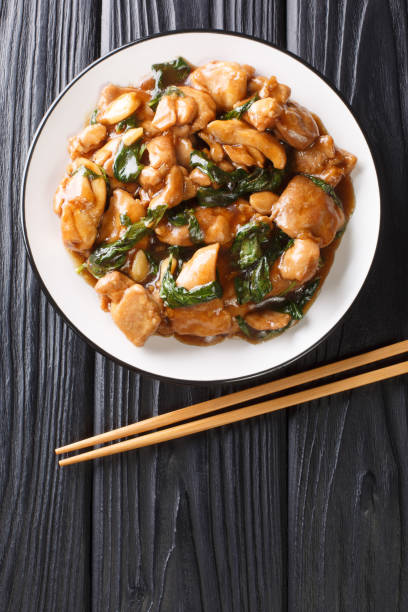 istock Three cup chicken, also known as Sanbeiji is an iconic chicken dish in Chinese cuisine, especially popular in Taiwan closeup on the plate. Vertical top view 1281081014