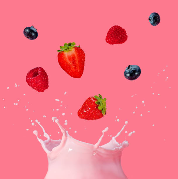 istock berries fallingo into a splash of pink milkshake 1281081023