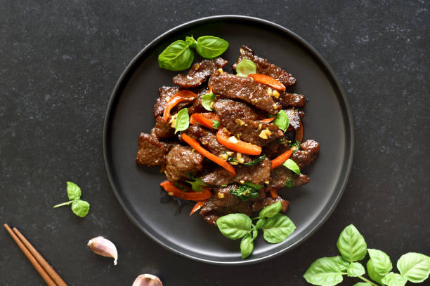 istock Thai style stir-fry beef with vegetables on plate 1281081092