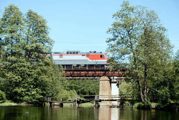 istock The train travels over the railway bridge over the river. 1281081191