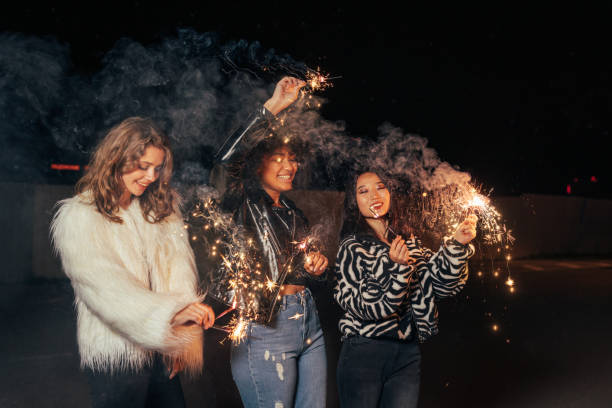 istock Three happy girls walking at night with sparklers and having fun 1281083638