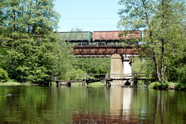 istock The train travels over the railway bridge over the river. 1281083844