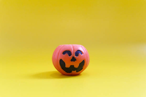 Halloween pumpkins on the yellow paper background. Halloween background. Space for text. copy space.