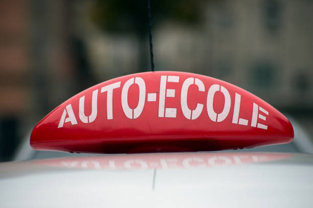 french driving school panel on the car roof , text in french "auto ecole", traduction in english "driving school" closeup of french driving school panel on the car roof , text in french "auto ecole", traduction in english "driving school" ecole stock pictures, royalty-free photos & images