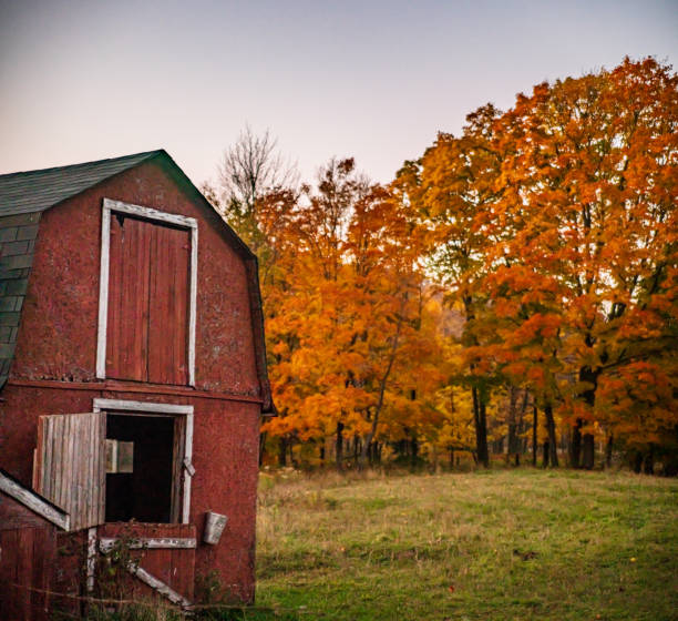 istock Red Barn with Autumn Landscape in the Background 1281085918