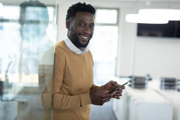 istock Portrait of Businessman using smartphone at modern office 1281086683