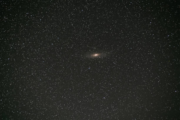 istock Black night stars covered sky with bright Andromeda galaxy in the middle. 1281086696