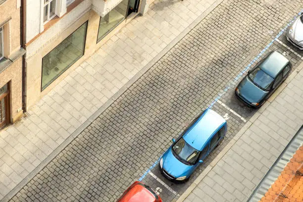 Top view of many cars parked on a city street.