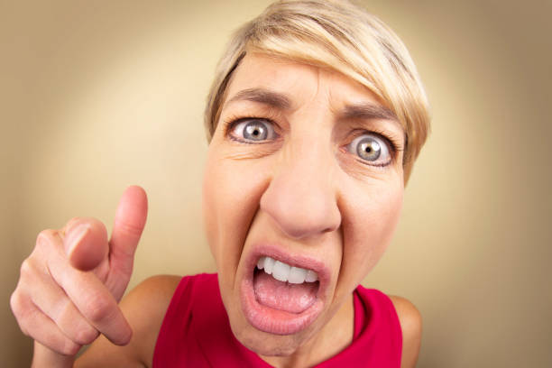 Angry Fisheye Woman A fisheye photo of a livid woman screaming and pointing. ugly face stock pictures, royalty-free photos & images