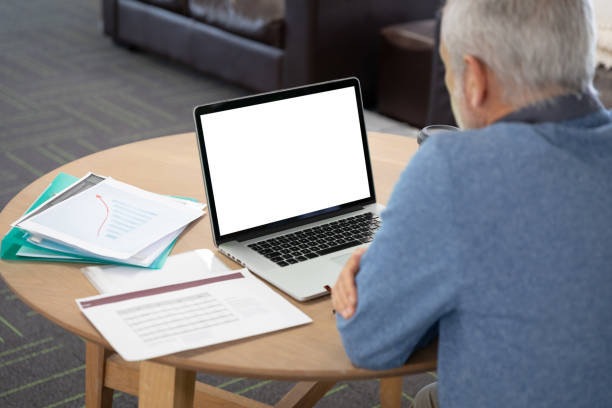 istock Senior businessman using laptop at modern office 1281089117
