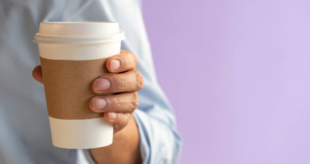 istock Disposable Coffee Cup in Male Hand 1281090453