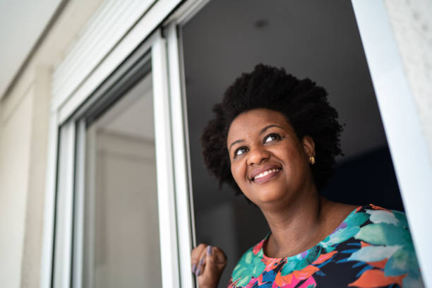 istock Thoughtful woman looking through the window at home 1281090765