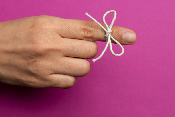 hand and string tied on index finger - reminder memories human finger string imagens e fotografias de stock