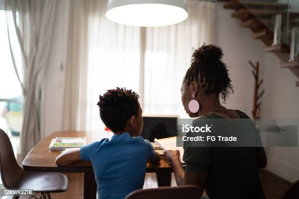 Rear View Of Mother And Son Studying At Home Stock Photo - Download Image Now - Rear View, African Ethnicity, Mother
