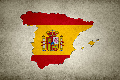 Grunge map of Spain with its flag printed within its border on an old paper.