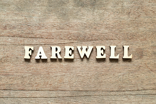 Alphabet letter block in word farewell on wood background