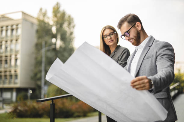 istock Civil architects reading document and checking new project outdoors 1281093802